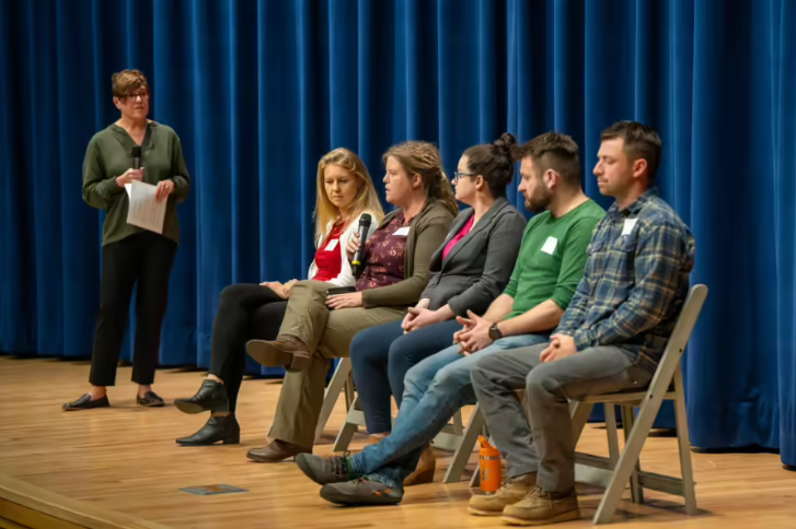 discussion panel participants on stage. Photo by Eric Teed